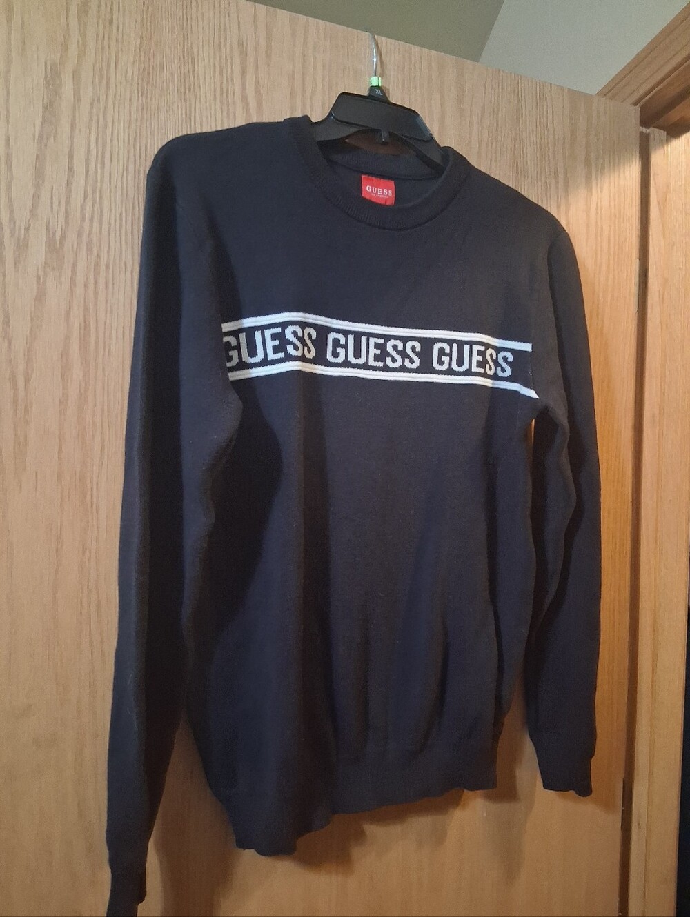 GUESS long-sleeve crewneck sweater, bold white chest stripe with repeating Guess